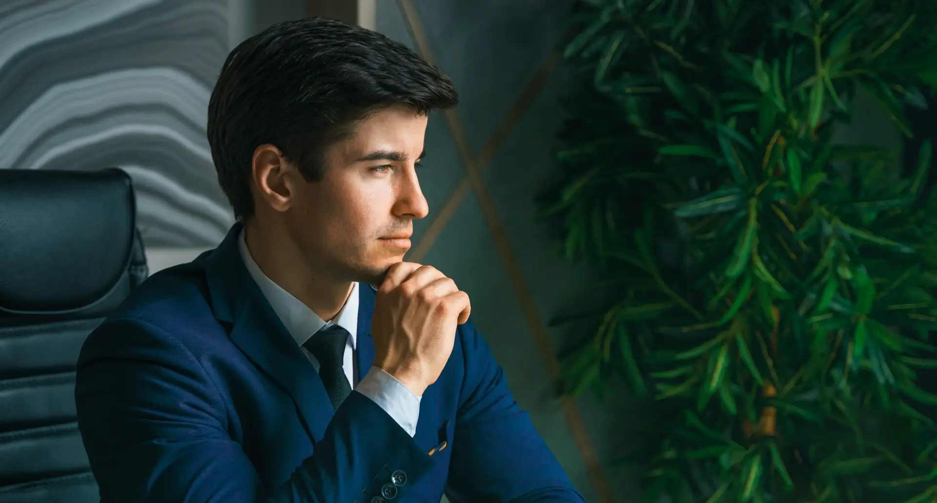 Businessman working with laptop in modern office. General manager,ceo. Young handsome confident man in suit sitting at table. Executive business leader. Entrepreneur career.Accountant bank workplace