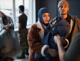 Middle Eastern Refugee Couple Giving Interview in Shelter